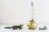 Herb oil with rosemary, thyme and lavender in a glass jar