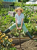 A young girl in a allotment garden