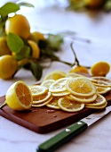 Thinly Sliced Lemons on a Cutting Board