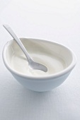 Creme fraiche in a small bowl with a spoon