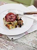 Toasted bread with mushrooms, cheese and bacon on a rustic table