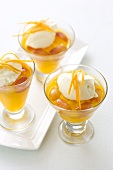 Orange-mango jelly with grapes, cream and orange zest