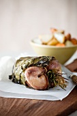 Quail wrapped in grapevine leaves with rosemary