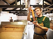 Workers with sample in fermentation room