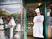 Baker standing in cake shop