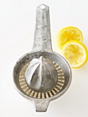 Lemon Juice in Juicer with Squeezed Lemon Remains