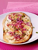 Tarte flambée with apples and red onions