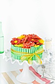 A birthday cake decorated with sugar gerberas