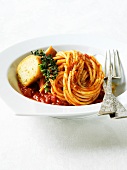 Bowl of Spaghetti with Tomato Sauce and a Slice of Bread