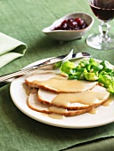 Thanksgiving Turkey Slices with Gravy and Brussels Sprouts; On a Plate