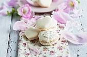 Vanilla macaroons with a rough surface; to the rear, heart-shaped macaroons
