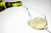 White Wine Pouring from Bottle into a Glass