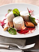 Poached cod with smoked fish on a beetroot salad