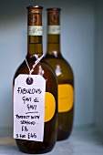 Two bottles of Gavi Di Gavi wine with a label