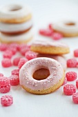 Doughnuts with pink sugar icing and raspberry drops