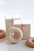 Doughnuts with pink and white sugar icing as a gift