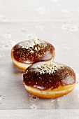 Two chocolate-glazed doughnuts