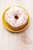 An iced doughnut with sugar sprinkles