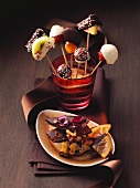 Cake pops and broken chocolate with candied fruits