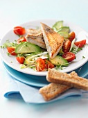 Avocado salad with cherry tomatoes and fish fillet