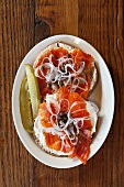 A Bagel with Lox, Capers and Red Onion; Pickle Spears