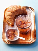 A croissant with apple jelly with almonds