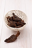 A bowl of dried pointed morel mushrooms