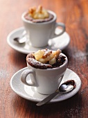 Chocolate puddings in cups with a pear and nut compote