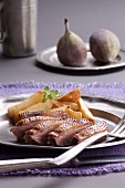 Duck breast with roast potatoes and fresh figs in the background