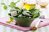 Spinach salad with fresh peas and feta cheese