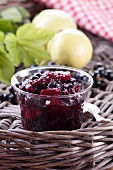 Blackcurrant and apple jam in a glass jar