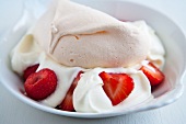 A yogurt dessert with fresh strawberries and meringue