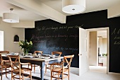 Dining room with black wall painted with blackboard paint
