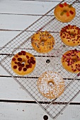 Doughnuts with various toppings on a wire rack