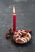A stuffed doughnut, star anise and a candle