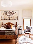 Bright bedroom with warm wooden hues; wooden bed with turned corner posts and retro armchair