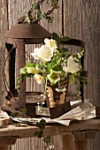 Bouquet made of white spring flowers in front of a rusty lantern