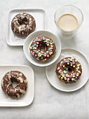 Chocolate Covered Donuts with White Chocolate Drizzles and Sprinkles