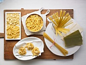 Various types of pasta on a chopping board