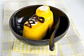 A shoe-shaped pudding in a black bowl