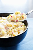 Spoonful of Potato Salad with Bowlful in Background