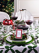 A Christmas place setting and red wine