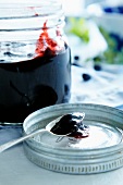Blueberry jam in jar and on a spoon