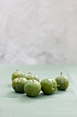 Greengages on a green cloth