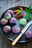 Blue figs on a wooden tray