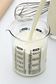 Milk being poured into a measuring jug