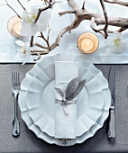 A Christmas place setting with an orchid
