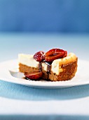 A slice of ricotta cake with strawberries and balsamic cream