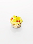 A cupcake decorated with lemon bonbon and sugar hearts