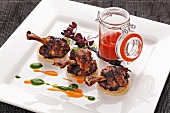 Spicy chicken legs on blinis with ketchup
